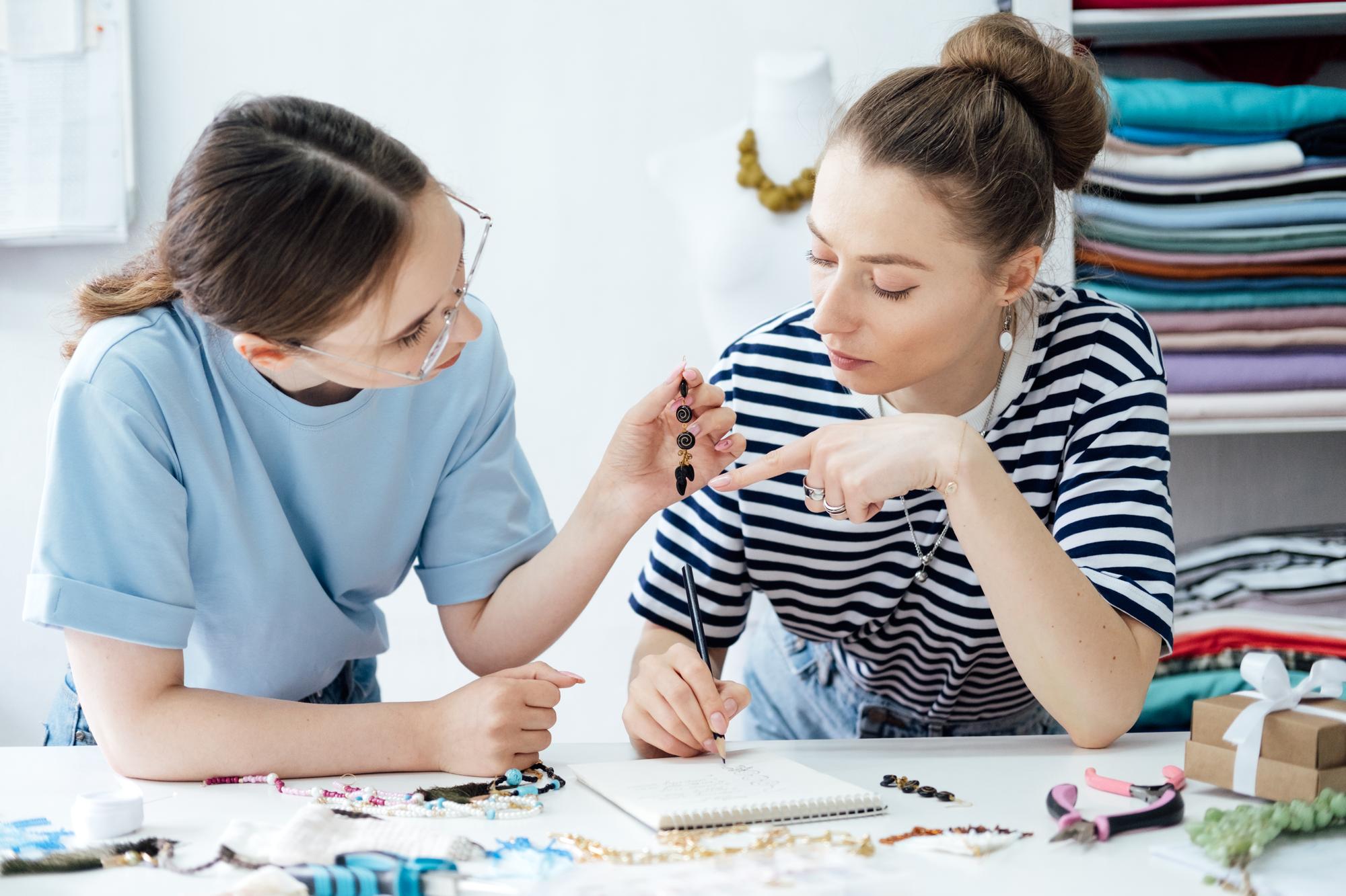 Instructor and student exchanging embroidery tips
