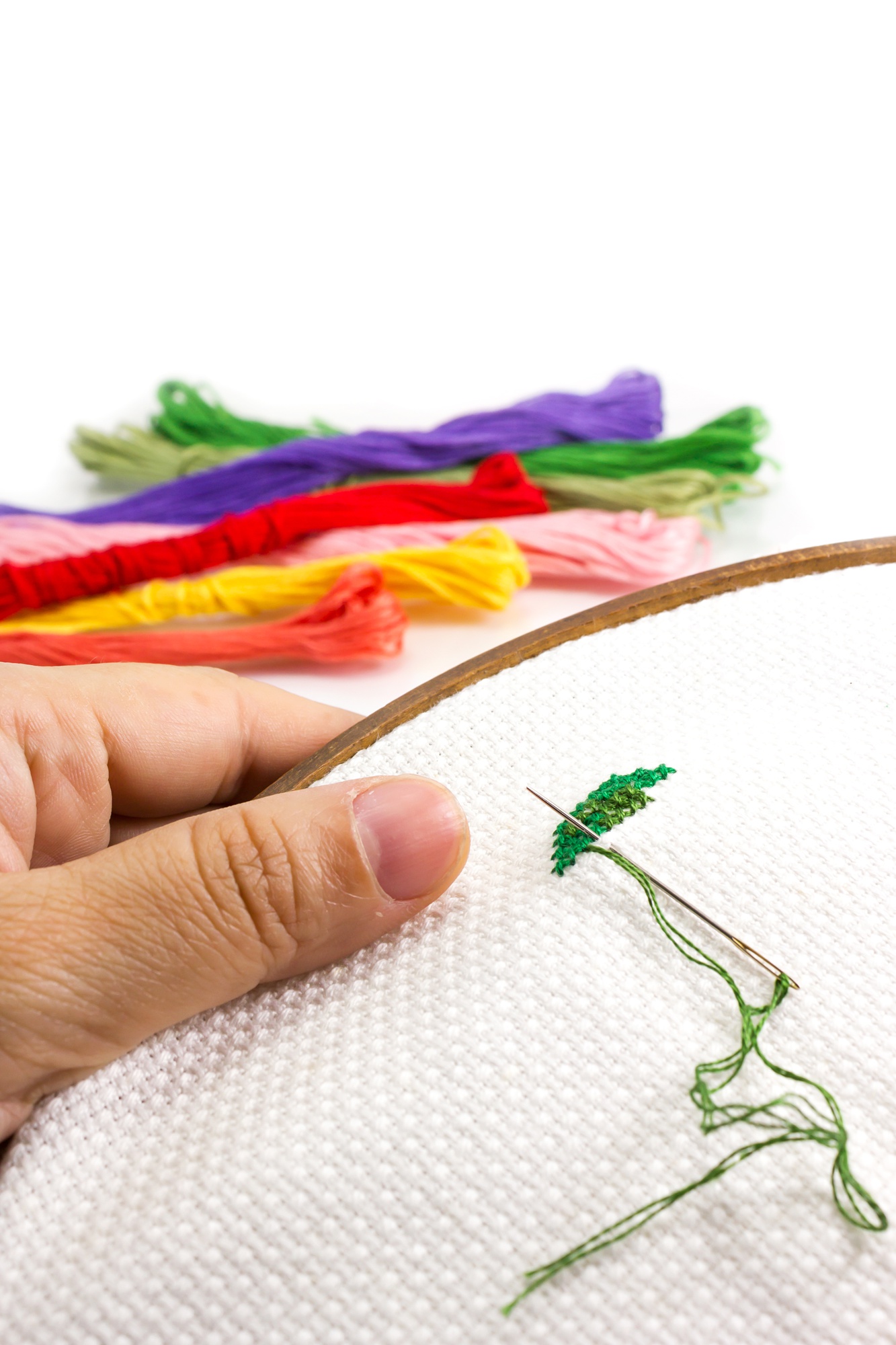 Close-up colorful floral embroidery on linen