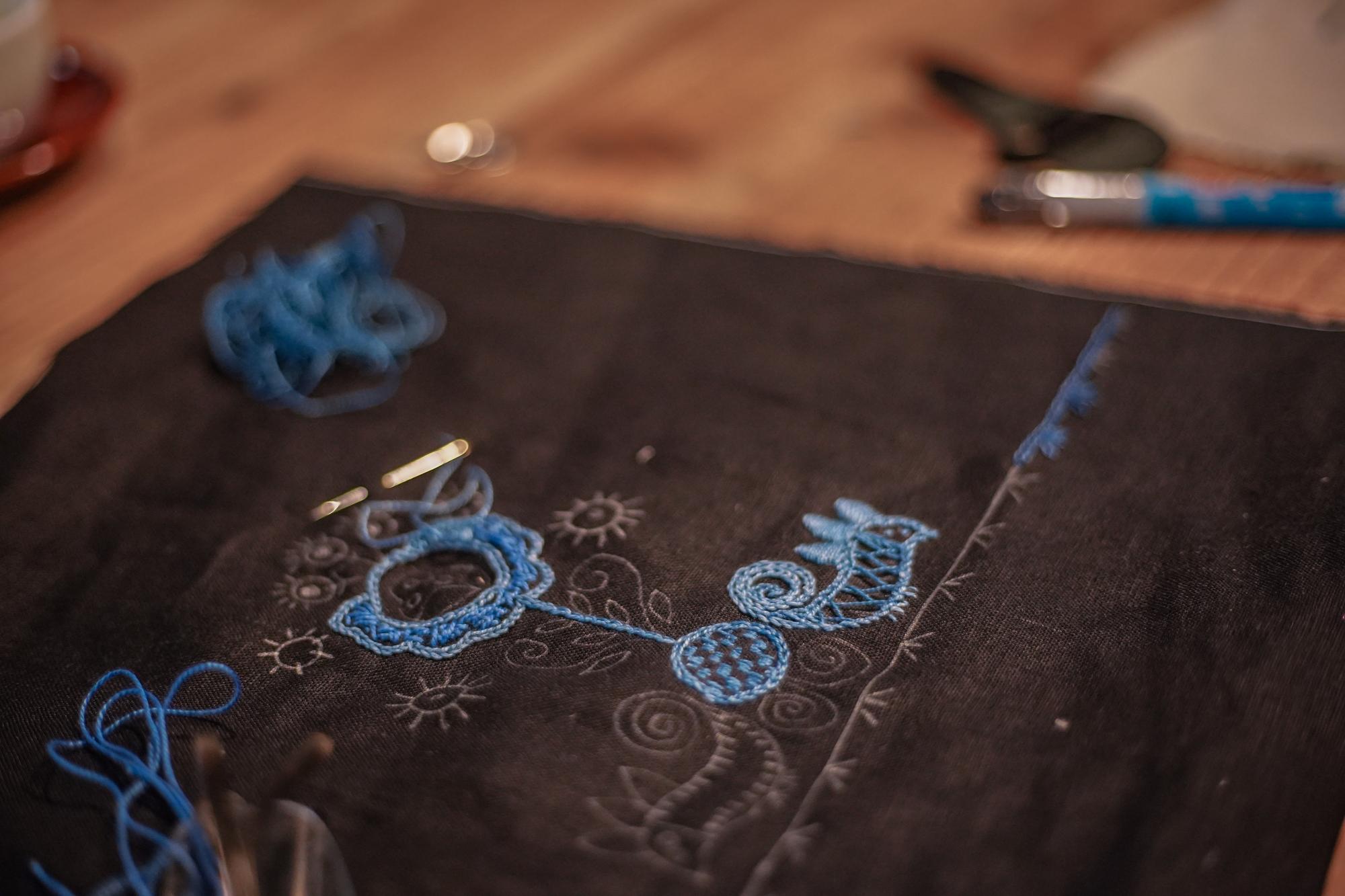 Artist hands stitching a geometric pattern