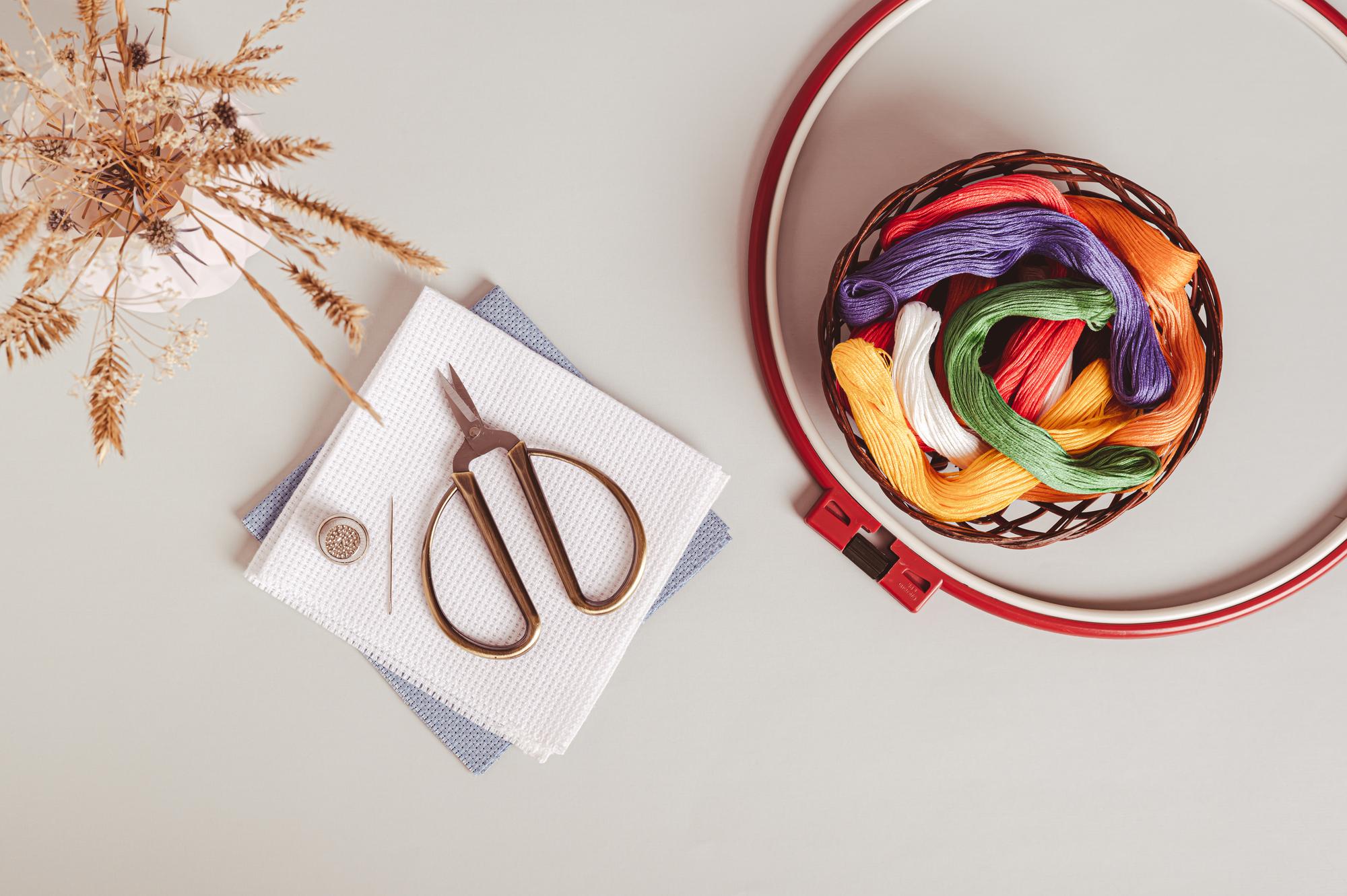 Studio with embroidery hoops and colorful threads on table
